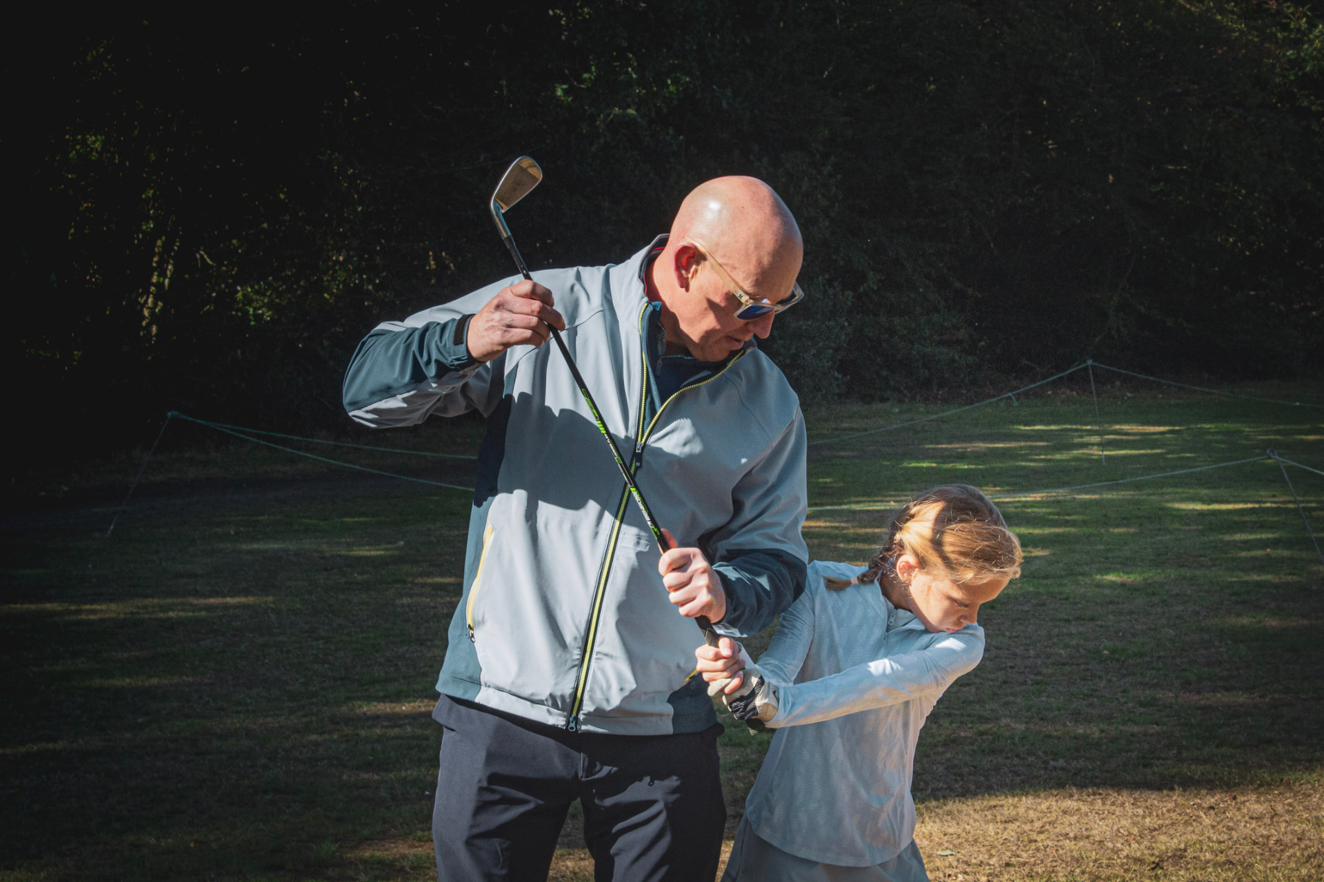 Kevin Evans helping a young player with her swing