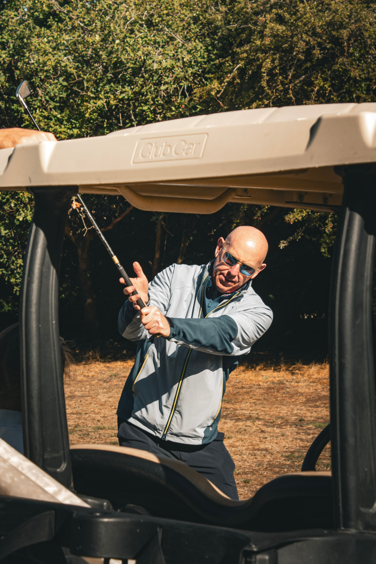 Kevin Evans coaching a swing from a golf cart