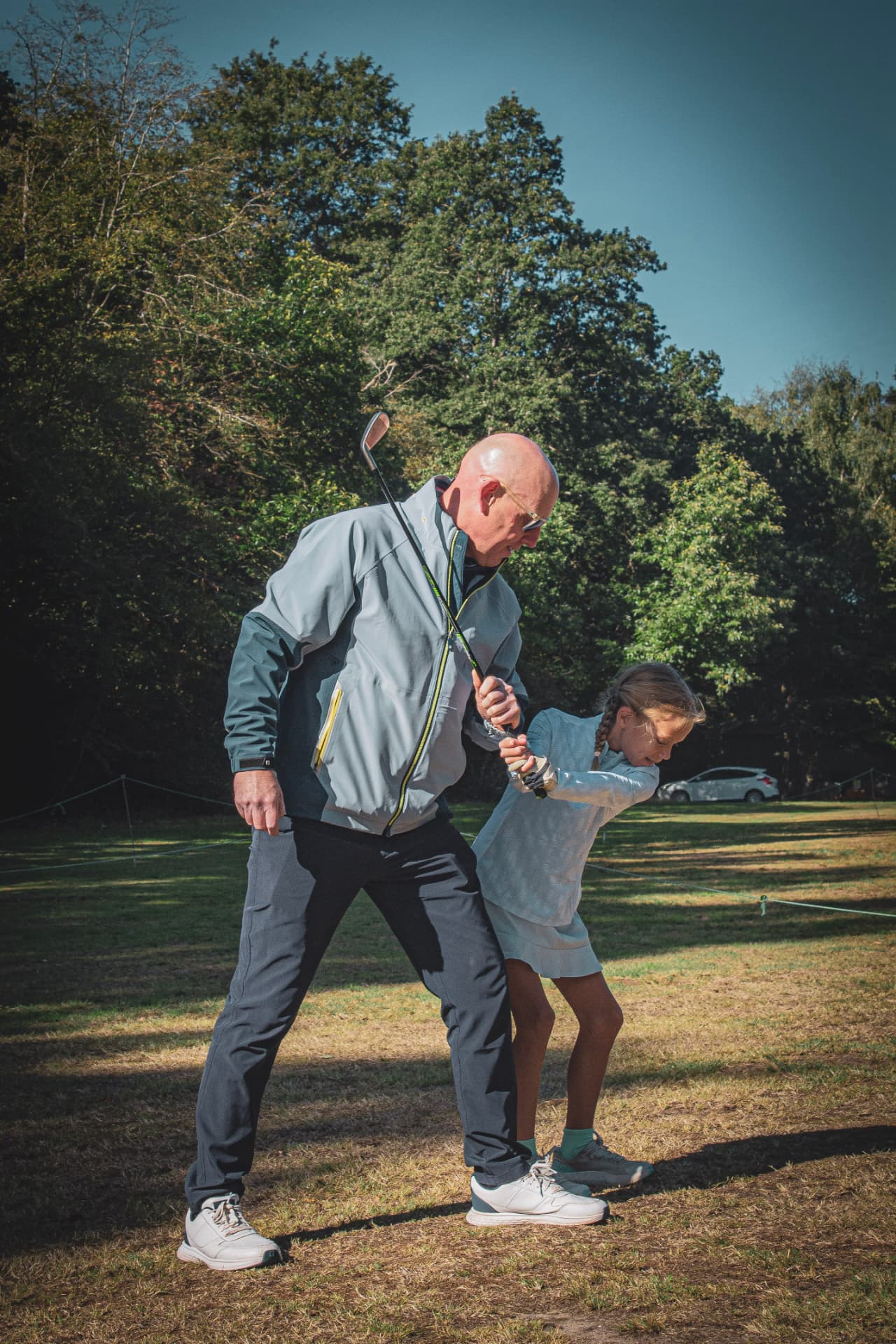 Kevin Evans adjusting a junior golfer's grip during a lesson