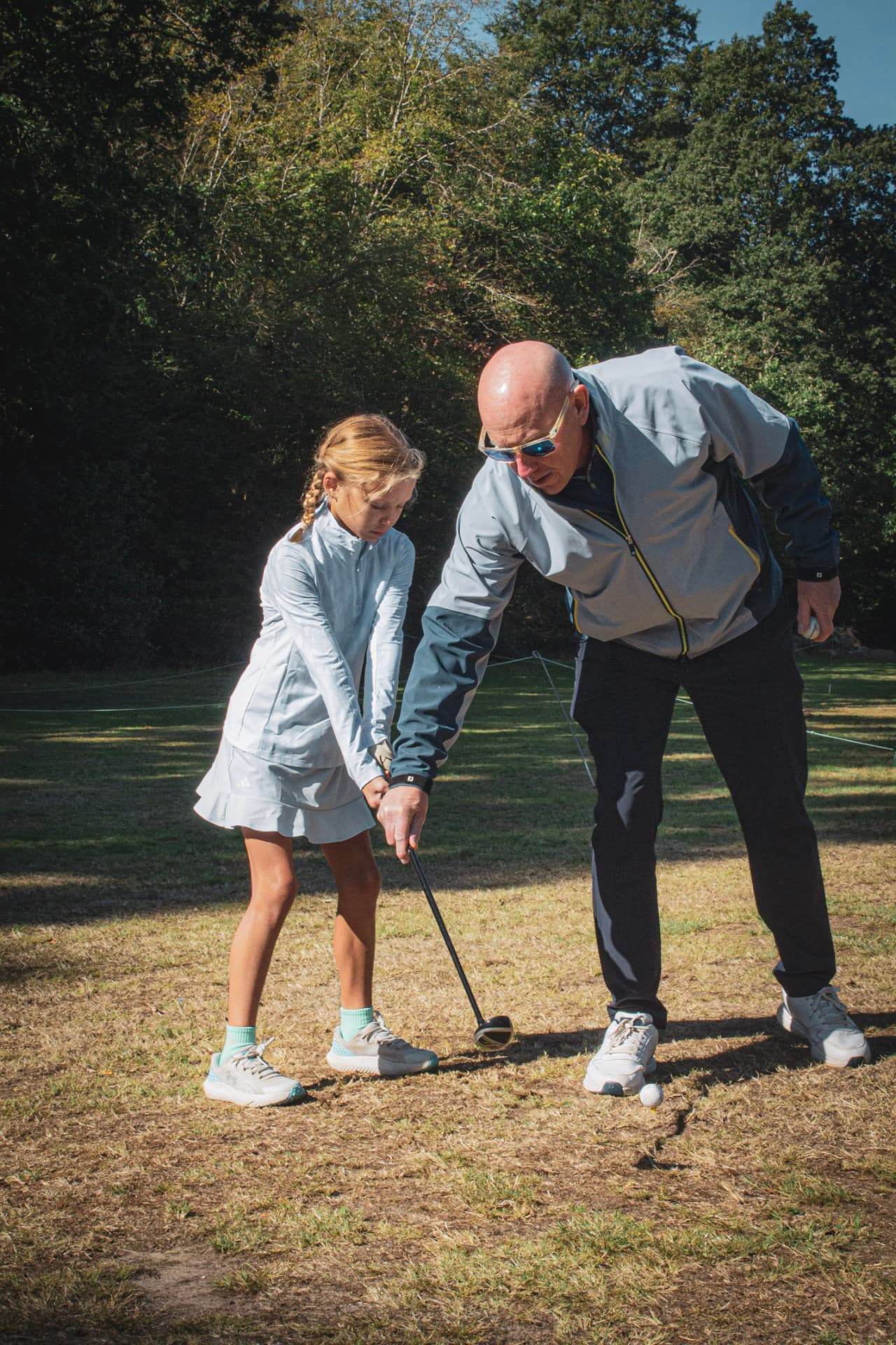 Kevin Evans coaching a junior golfer on the tee