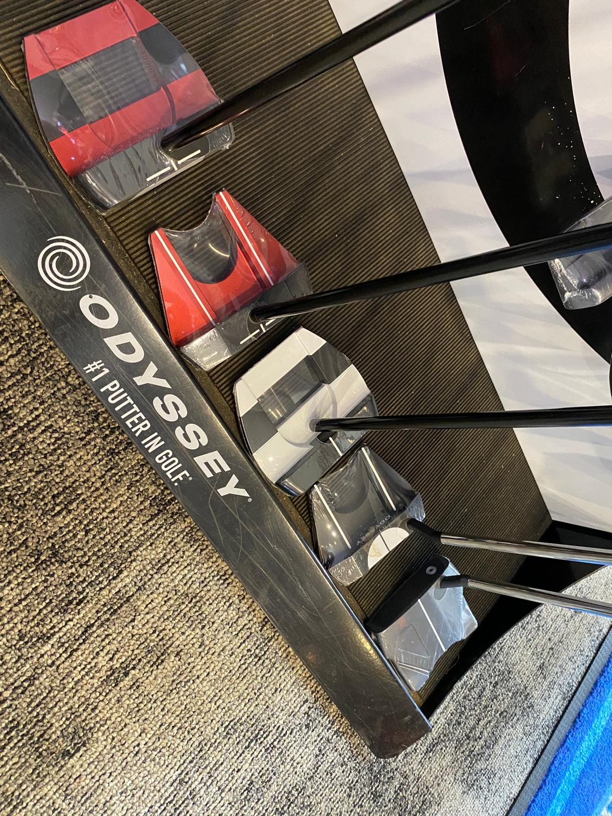 Odyssey putters on a pro shop display